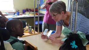 special education teacher in Haiti instructing child with special needs - Watson Institute