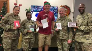 Soldiers holding holiday cards from students with special needs