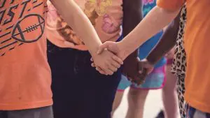 children holding hands image for thoughts for families in a hard time - Watson Institute