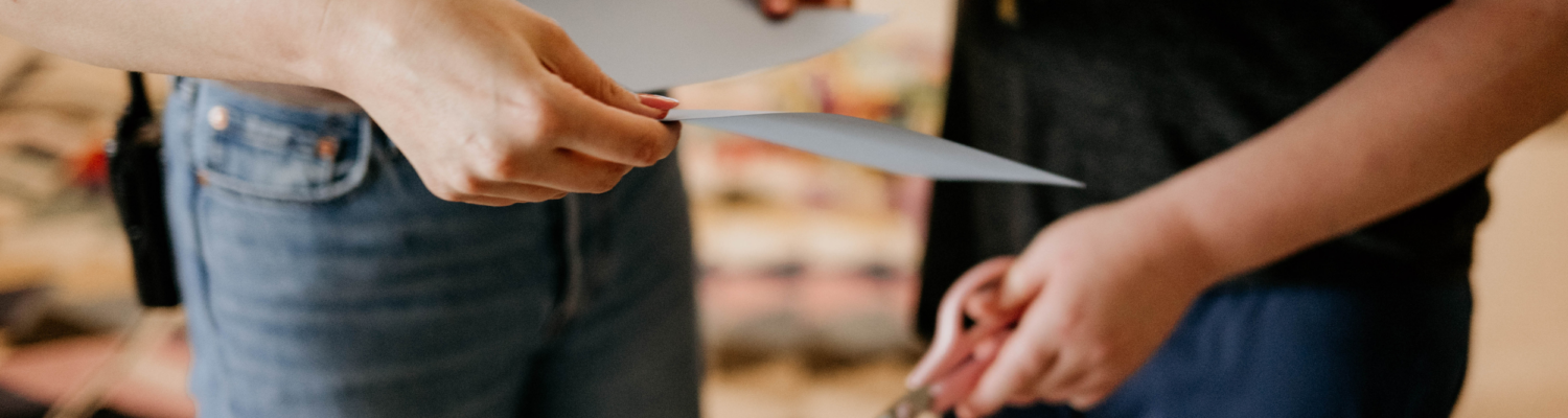 close up image of teacher and student's hands holding school supplies