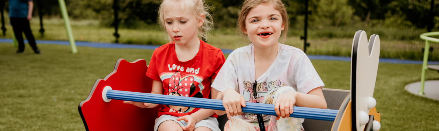 two young students with disabilities pictured outside on the school playground