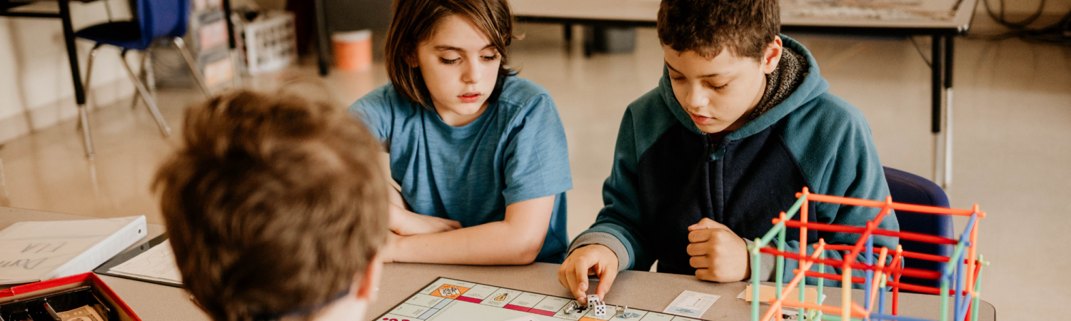 students with autism seated in their classroom playing a game together