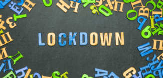 letters aligned on a chalkboard spell out "lockdown"