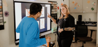 A behavior technician in the classroom with a student at the Watson Institute