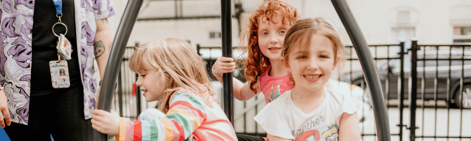 LEAP inclusive preschool students on a swing together on playground - Watson Institute