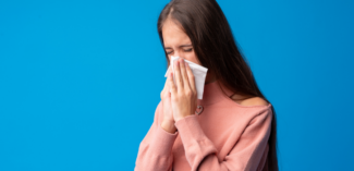 teen pictured blowing their nose using a tissue appropriately - Watson Institute