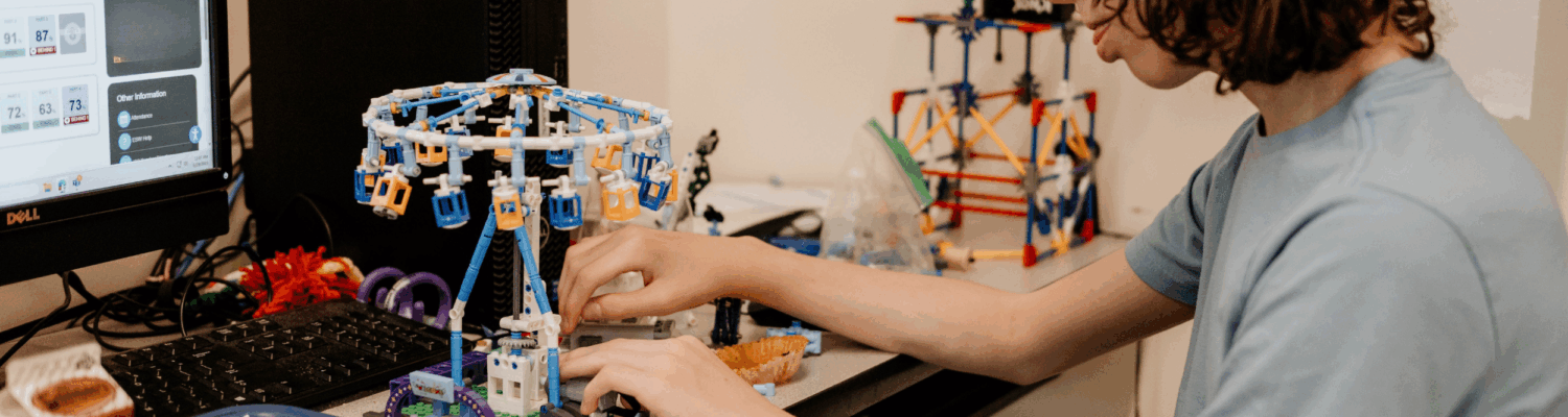 autistic student with a makerspace creation in the classroom - Watson Institute