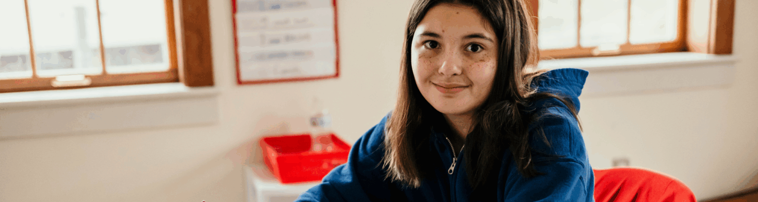 autistic student at her desk in her classroom - Watson Institute