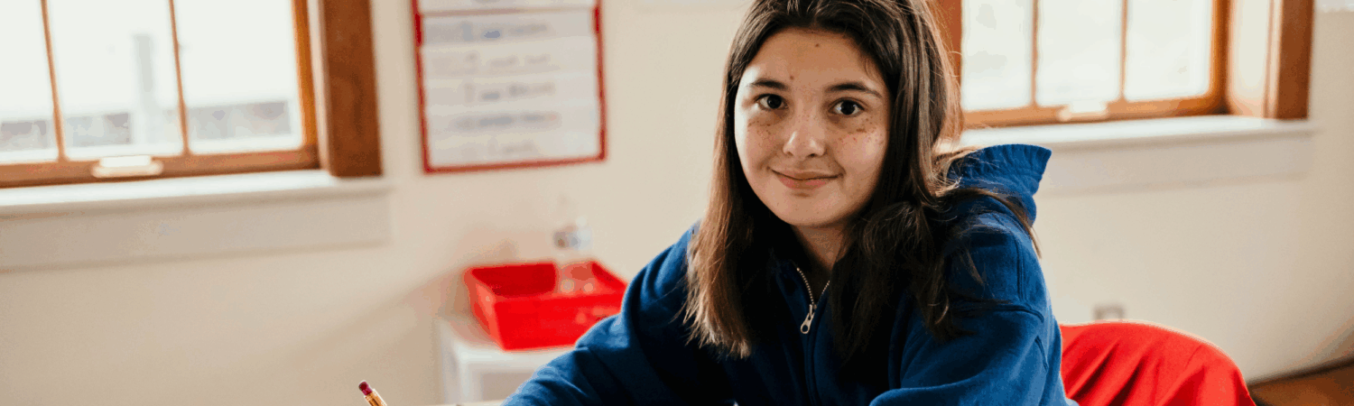 autistic student at her desk in her classroom - Watson Institute