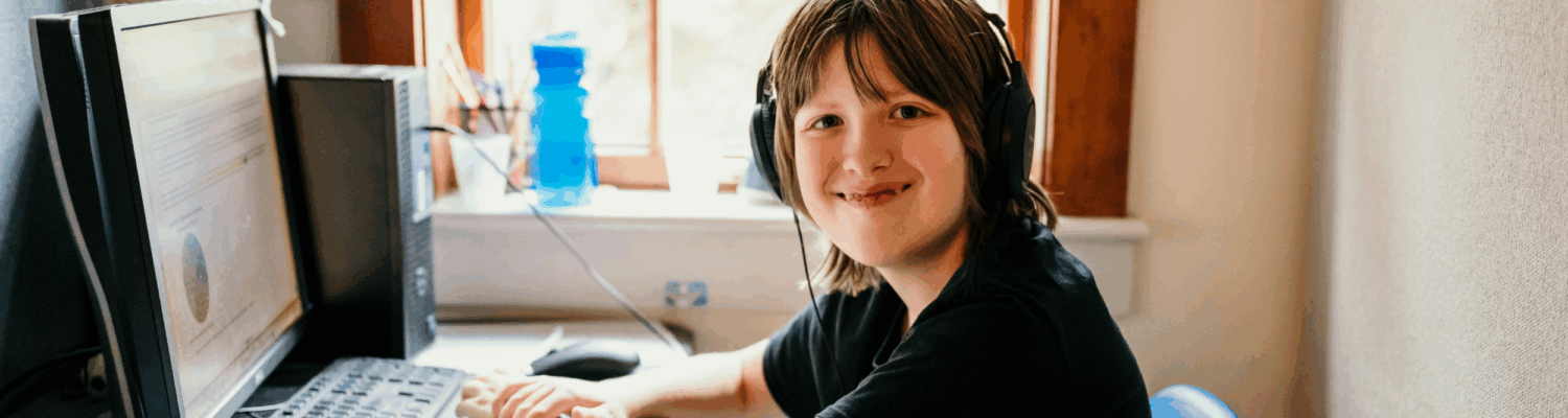 young autistic student sitting at his desk in the WISCA classroom - Watson Institute