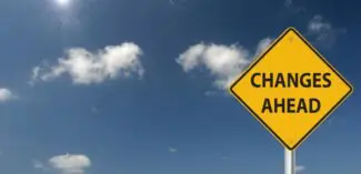 road sign that reads "changes ahead" set against a blue sky