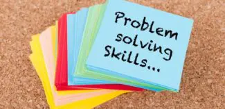 a stack of sticky notes that reads "problem solving skills" on the topmost note
