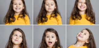 young child making faces to show different emotional expressions - Watson Institute