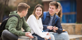 teens engaged in conversation showing happy and relaxed body language and facial expressions - Watson Institute