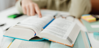 student searching through textbooks to find question answers using the QAR strategy - Watson Institute