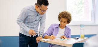teacher encouraging student to participate in class by asking questions during discussion - Watson Institute