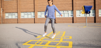 student playing outside during recess - Watson Institute
