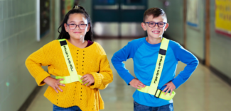 students wearing safety patrol badges demonstrating social safety awareness - Watson Institute