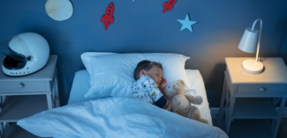 child sleeping soundly once parents use various sound sleeping strategies to establish a consistent routine - Watson Institute