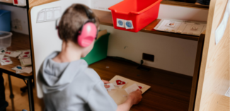 student pictured sitting at a study carrel to help with concentration on the task at-hand - Watson Institute