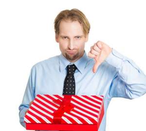 man holding christmas present with thumbs down