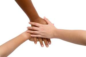 three children's hands stacked on each other