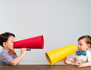 two children pictured with colorful megaphones in hand