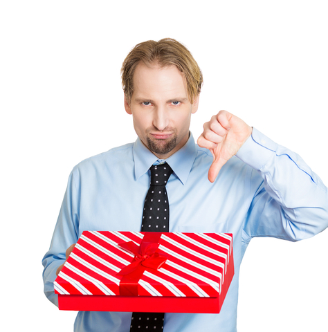 man holding christmas present with thumbs down
