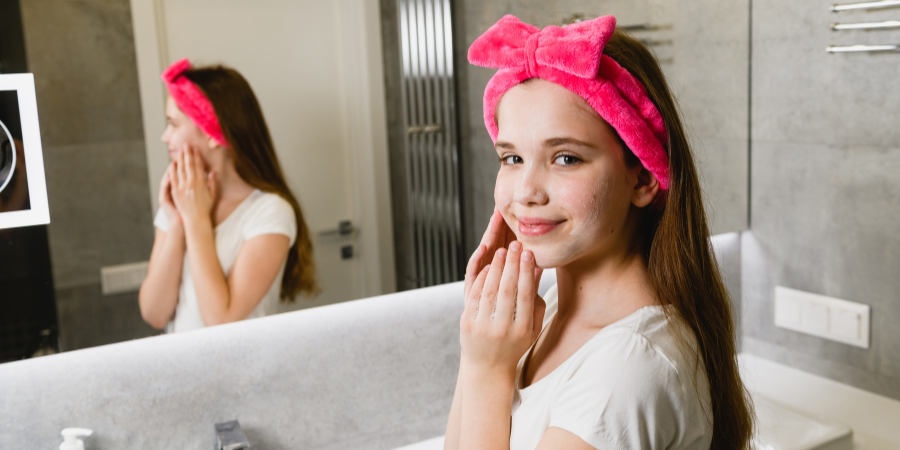 young girl washing her face in the bathroom