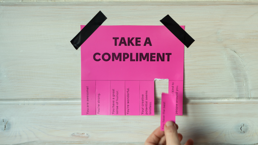 A poster hanging on the wall with pull tabs offering up free compliements.