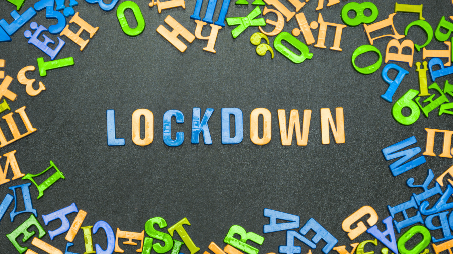letters aligned on a chalkboard spell out "lockdown"