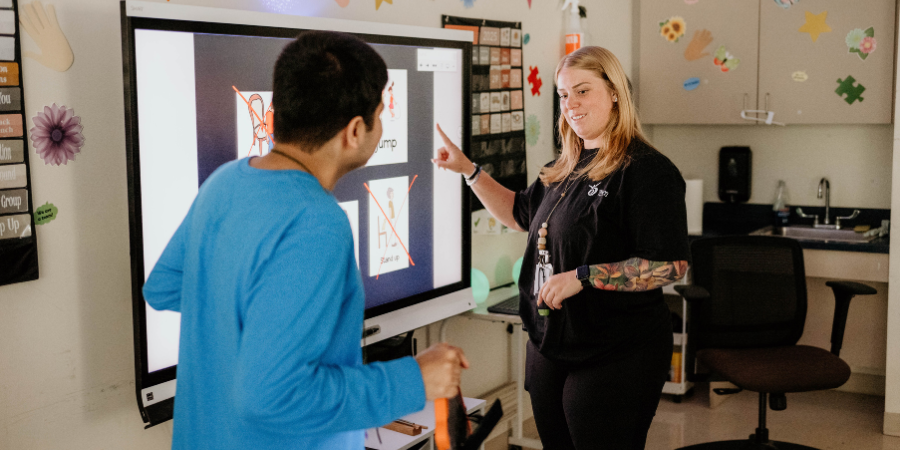 A behavior technician in the classroom with a student -Watson Institute