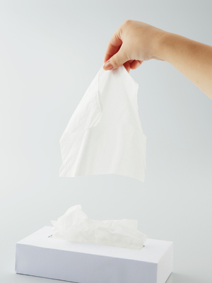 hand reaching for and holding a tissue to blow nose - Watson Institute