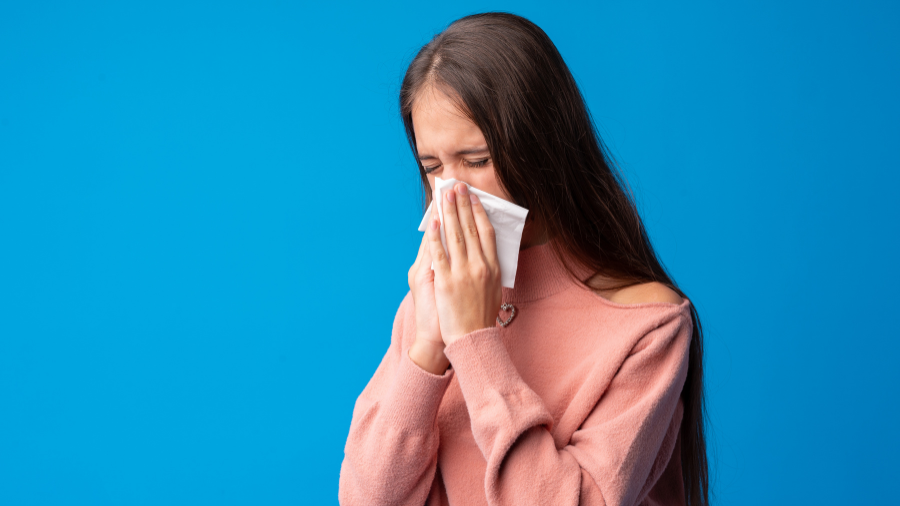 teen pictured blowing their nose using a tissue appropriately - Watson Institute