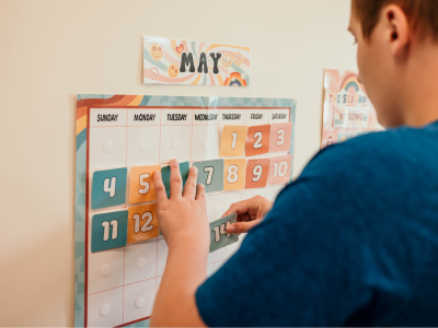 student using a calendar to count down the days until a visitor arrives as a behavior intervention - Watson Institute