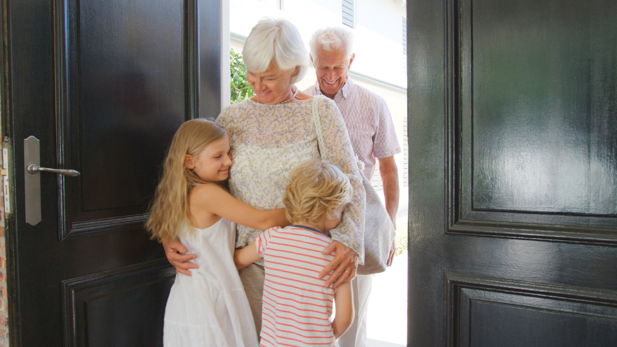 children welcoming their grandparents visiting their home - Watson Institute