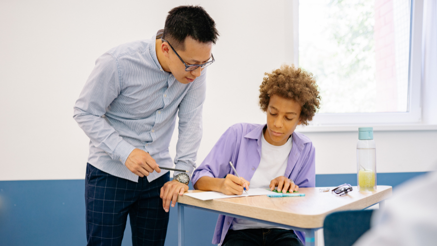 teacher encouraging student to participate in class by asking questions during discussion - Watson Institute