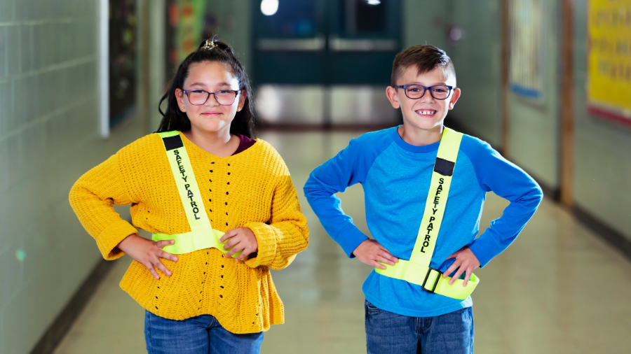 students wearing safety patrol badges demonstrating social safety awareness - Watson Institute