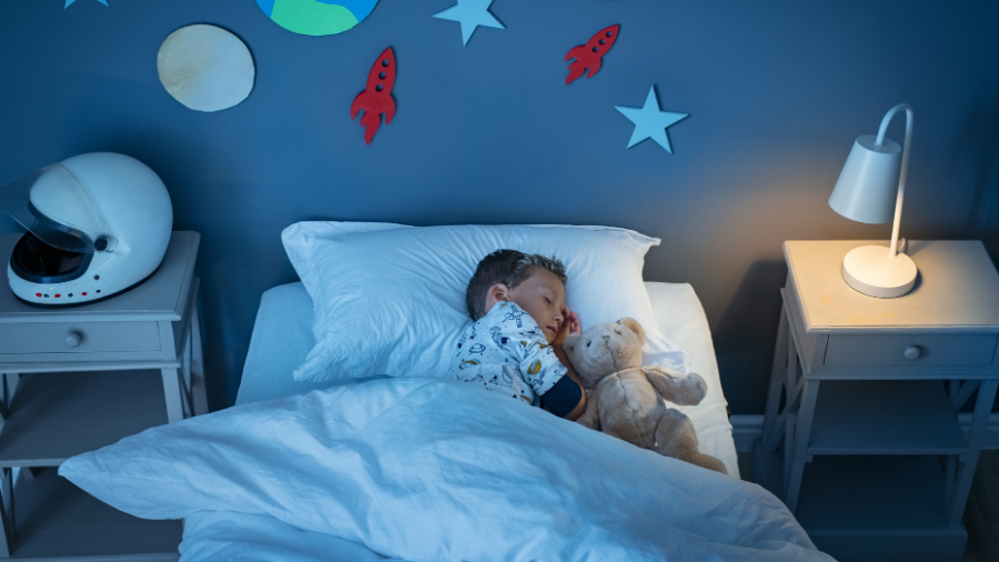 child sleeping soundly once parents use various sound sleeping strategies to establish a consistent routine - Watson Institute