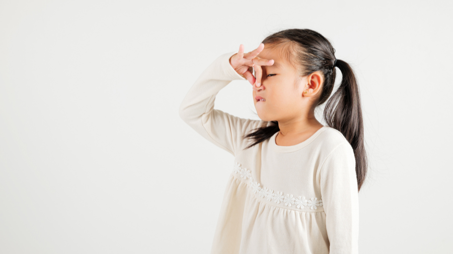child holds their nose as a strategy to cope with their sensitivity to smell - Watson Institute