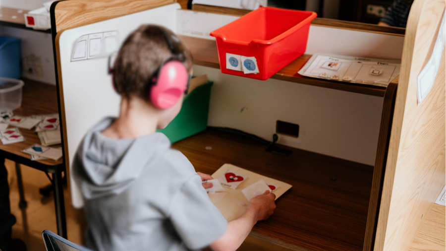 student pictured sitting at a study carrel to help with concentration on the task at-hand - Watson Institute